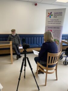 Ernest and Lisa conduct an interview whilst being filmed 
